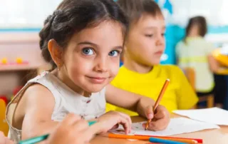 Group of cute little preschool kids drawing | Michigan Brain Health Boy and Girl Student